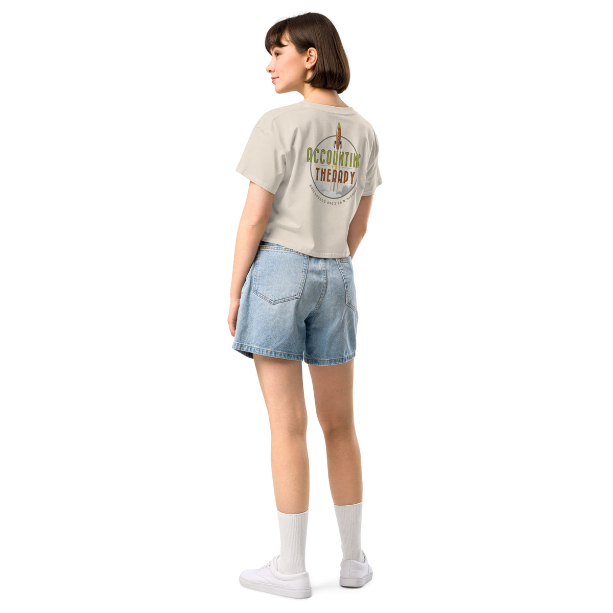 Product mockup - Back view of a bone-colored women’s crop top showing a short length t-shirt with a relaxed fit and short sleeves